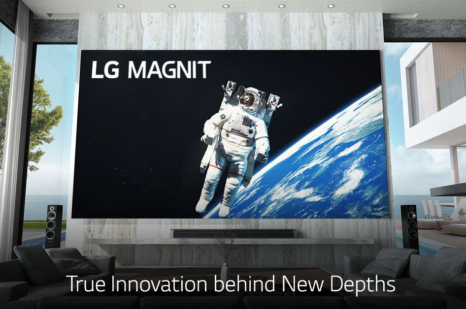 LG MAGNIT hanging on the wall of a modern living room as it displays an astronaut floating in space