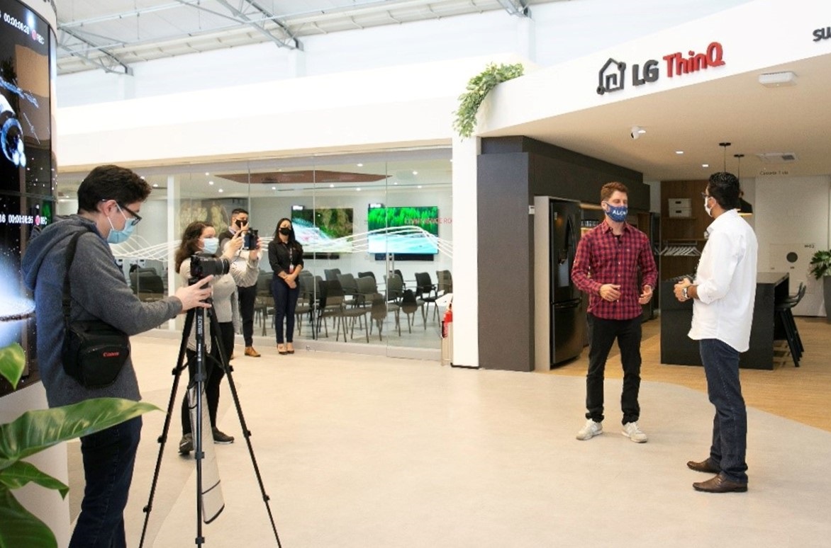 Two men discussing LG ThinQ at The LG Business Solution Center during filming.