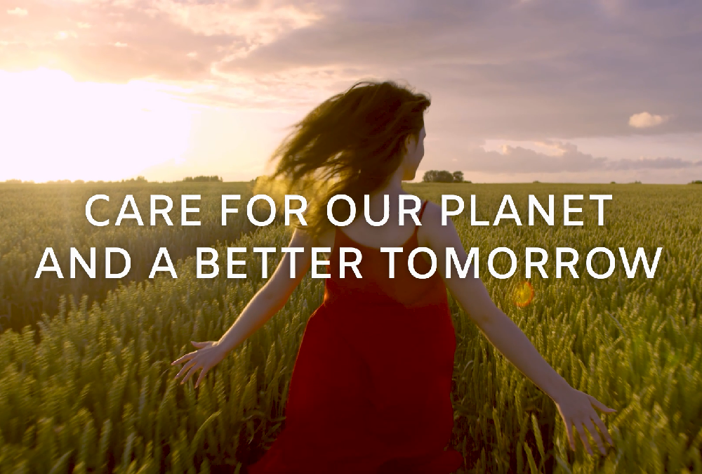 A girl in a red dress running through a field with the phrase "Care for our planet and a better tomorrow" overlapping.