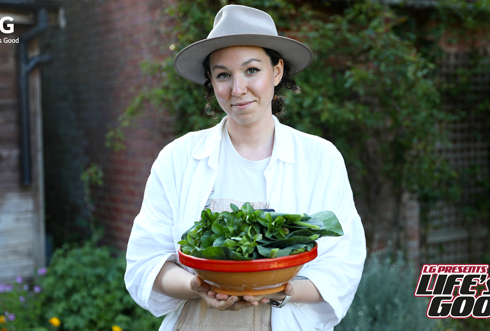 Immy posing with her homegrown vegetables which represent one of her ways of living sustainably.