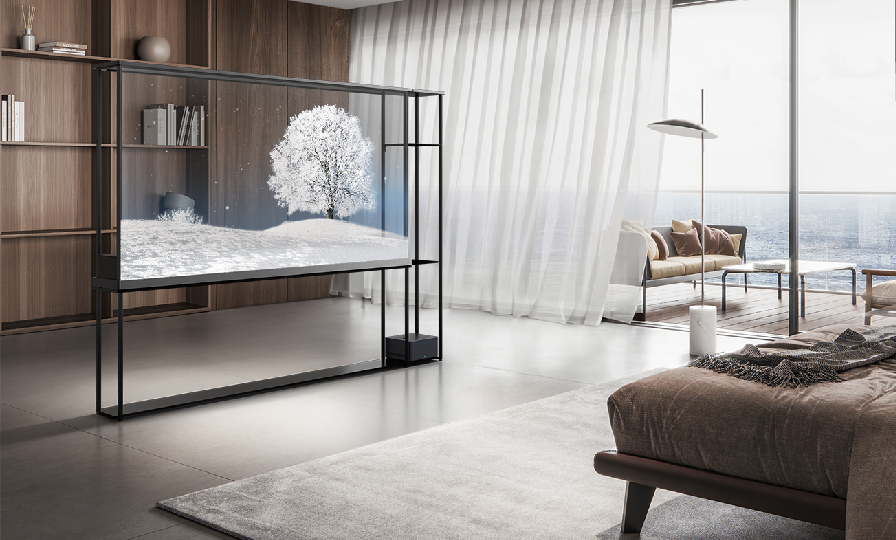 LG OLED T displays a snowy scene in a bedroom with a bookshelf visible behind the transparent screen