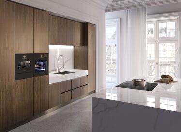 A photo of two SIGNATURE KITCHEN SUITE Built-in Ovens and a induction hob set up in a kitchen