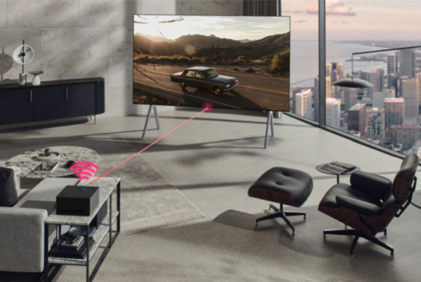 A image of living room setting with car on LG OLED M screen and the Zero Connect Box in front of it
