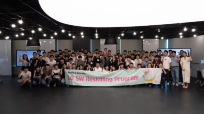 A picture of a group of people holding a banner that says 'LG SW Reskilling Program'