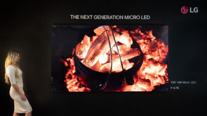 A photo of a woman looking at the woodfire image displayed on the LG Micro LED display