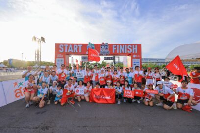 A group photo of participants in the 10K Race holding Life's Good banner