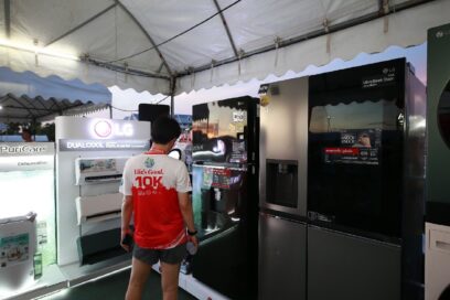 A Photo of a runner checking out LG products on display at the LG booth