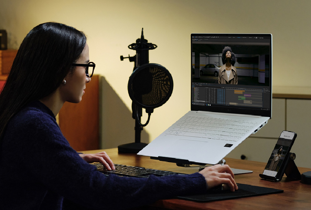 A photo of woman watching content displayed on the screen from the new LG gram 16 Pro