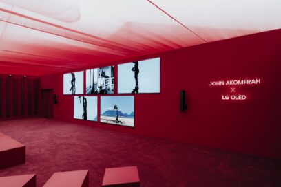 A group of wall-mounted LG OLED TVs showcases admired media artwork Becoming Wind, by John Akomfrah, at Frieze London 2024