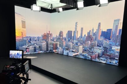 A photo of virtual production studio screen with a city view of numerous buildings